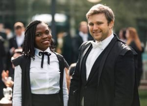 Graduands wearing sub fusc and Advanced student gown.