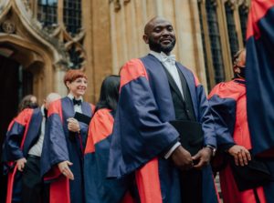 Graduands wearing the red and blue DPhil robe